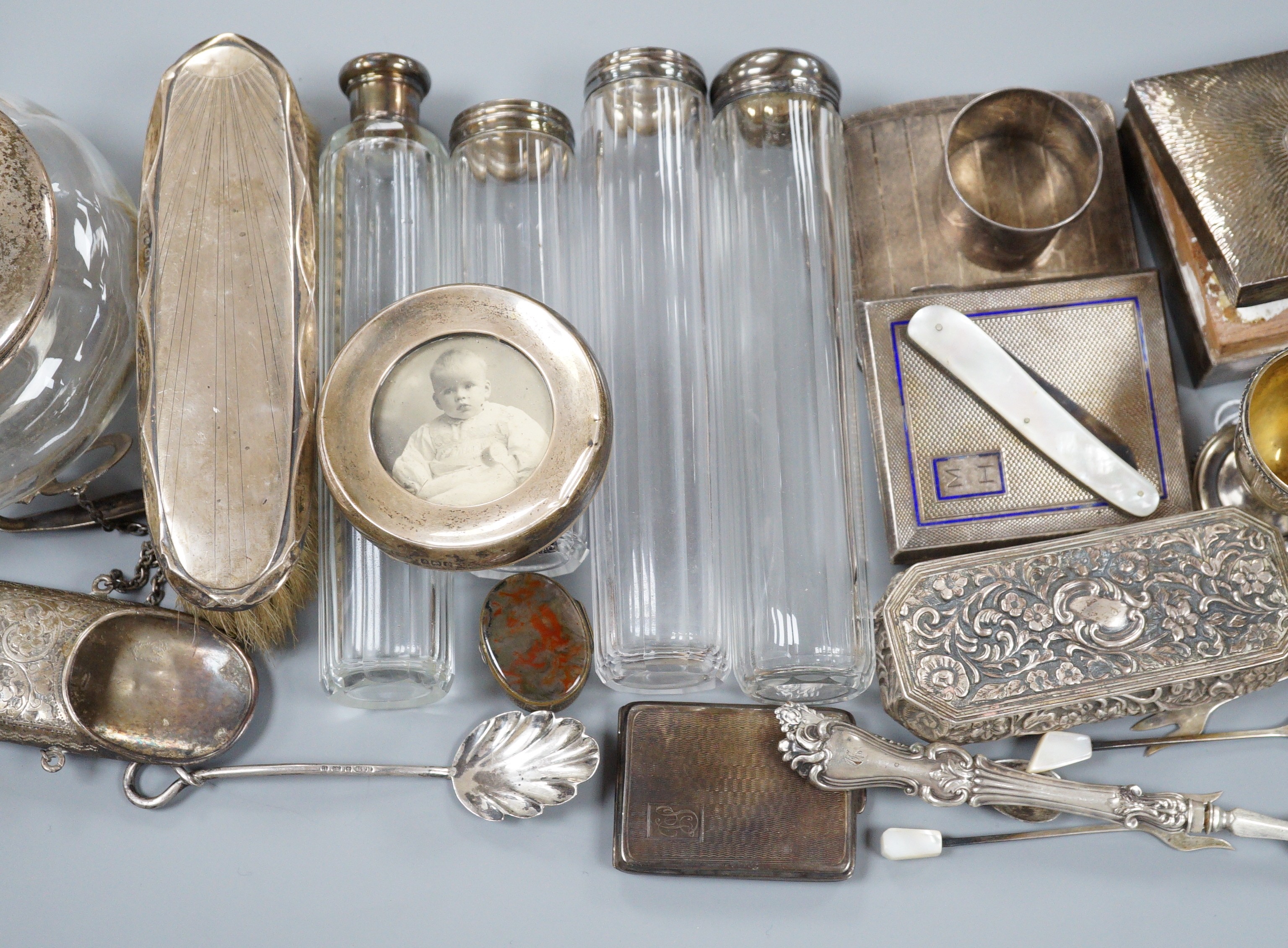 A collection of assorted collectable silver items, including a George V spectacles case, cigarette box, trinket box, Dutch spoon, mounted glass power jar, egg cup, enamelled cigarette case, vesta case, fruit knife, napki